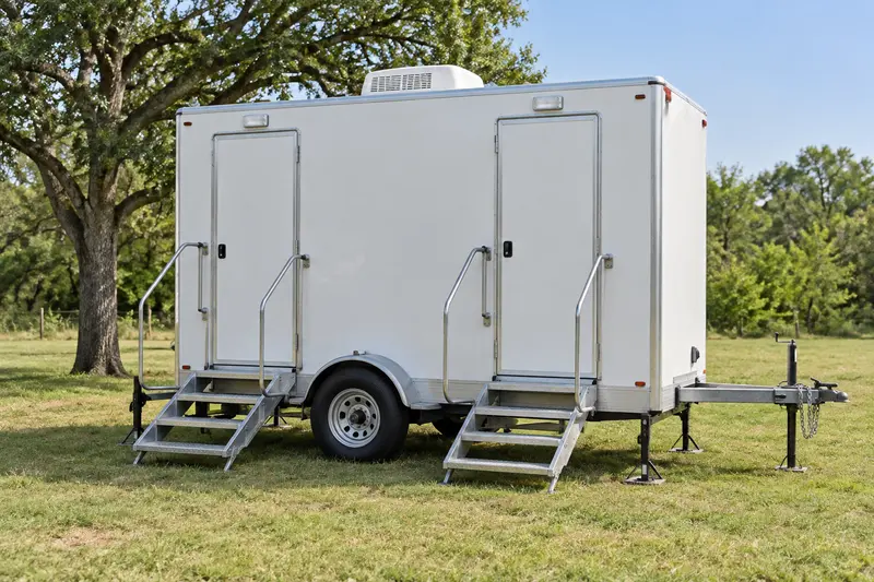 Portable restroom trailer and entrance rails